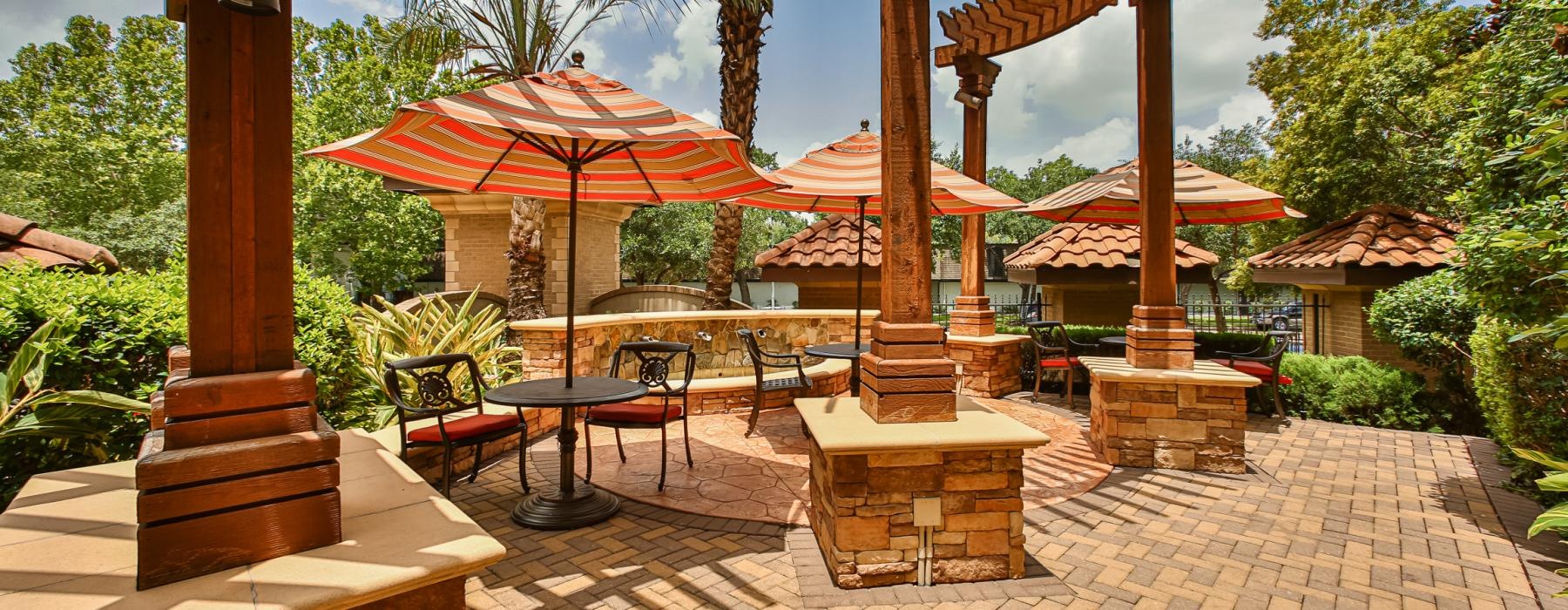 a patio with umbrellas and chairs
